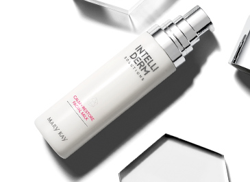 IntelliDerm Solutions™ Calm+Restore Facial Milk on a mirror surrounded by fluid formula.